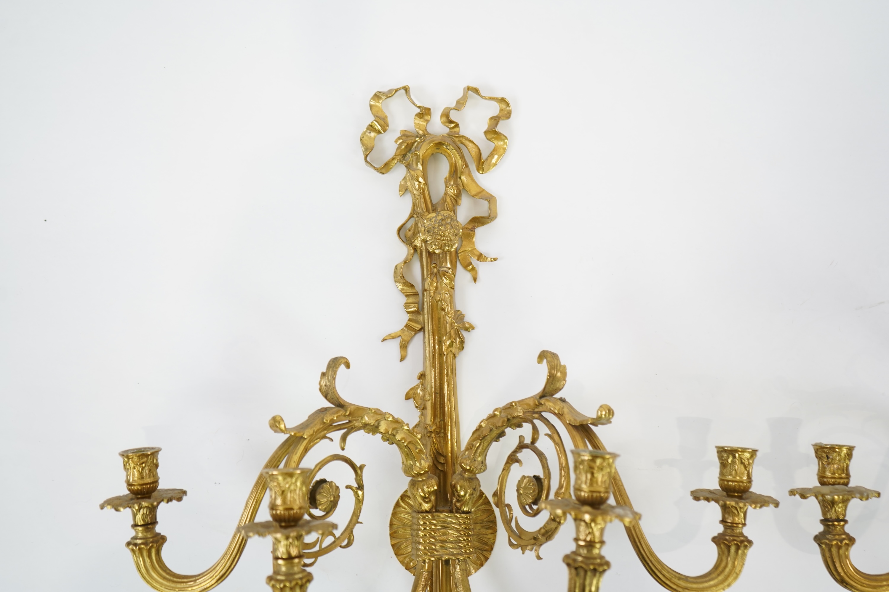 A pair of large Louis XVI style ormolu four branch wall sconces